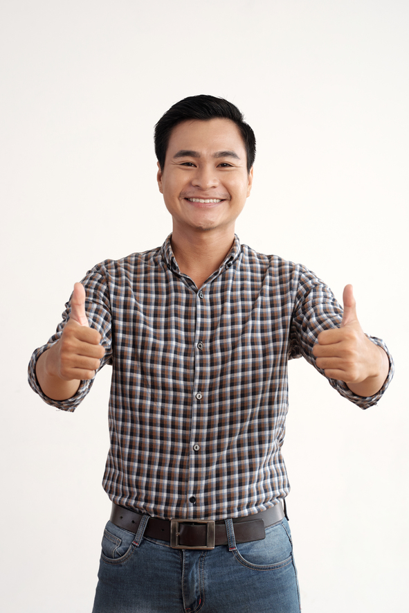 smiling asian man posing studio with thumbs up (1)